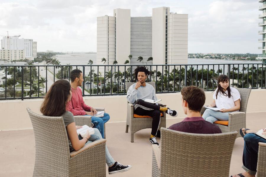 PBA students sit in a circle and talk.